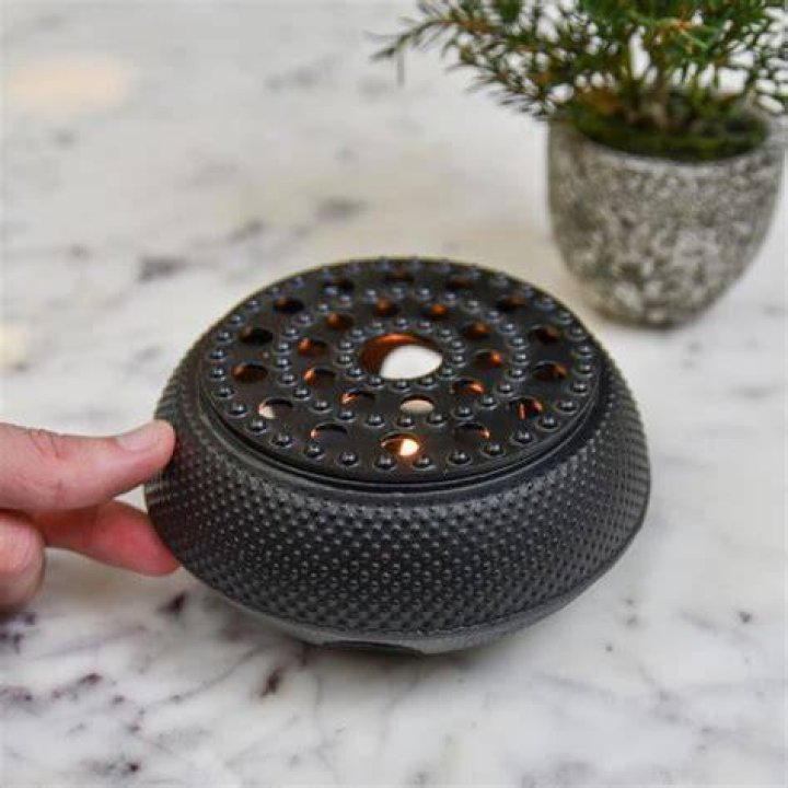 How do you use a cast iron teapot warmer?